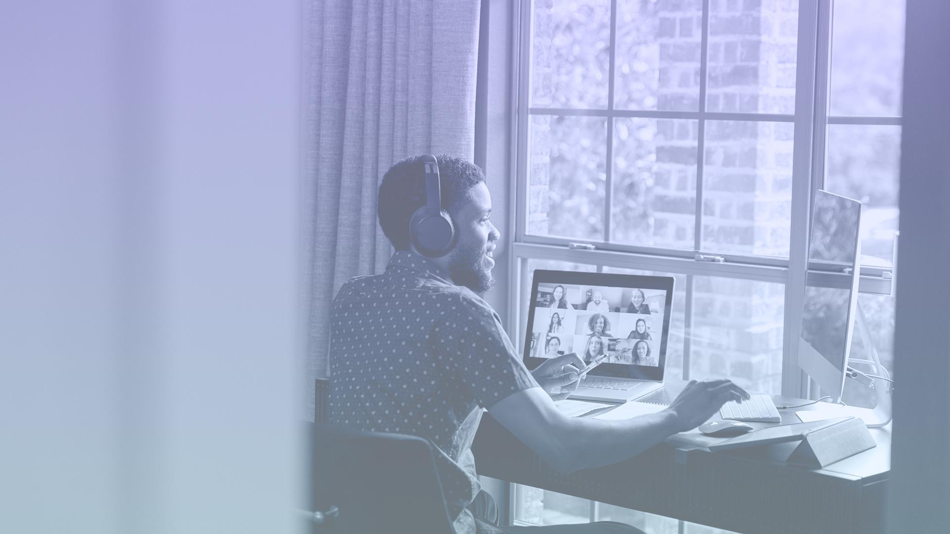 Young professional on a virtual meeting at his desk
