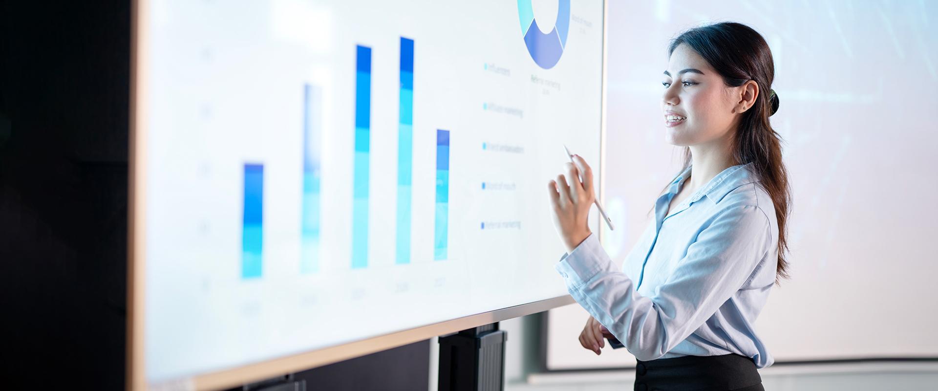 Woman working on a presentation on the white board