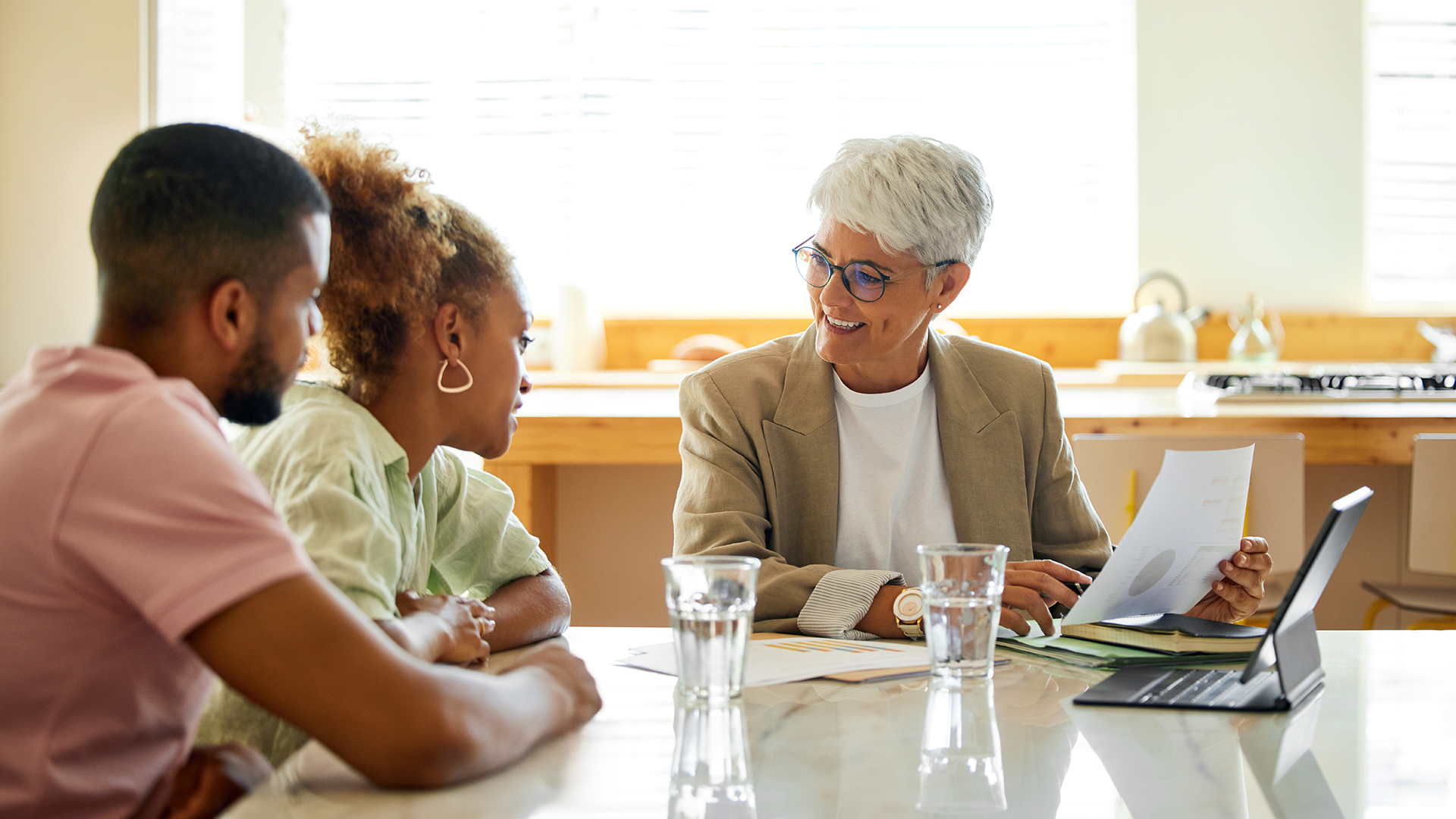 Senior financial advisor helping a young married couple