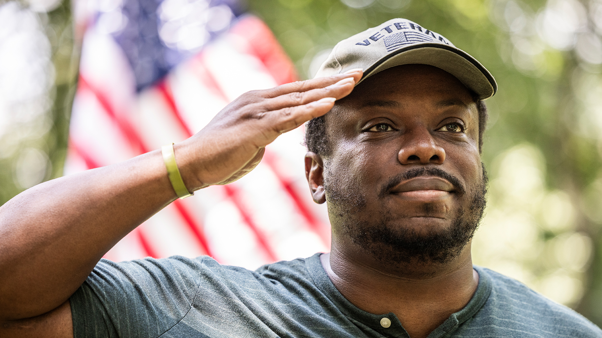 Veteran giving a salute in front of the American flag