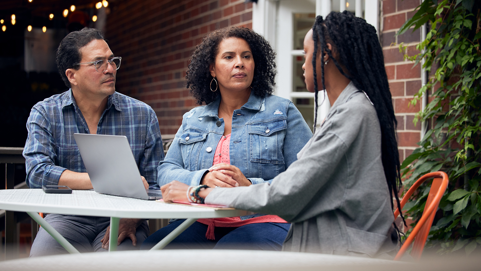 Parents talking with their daughter at the table