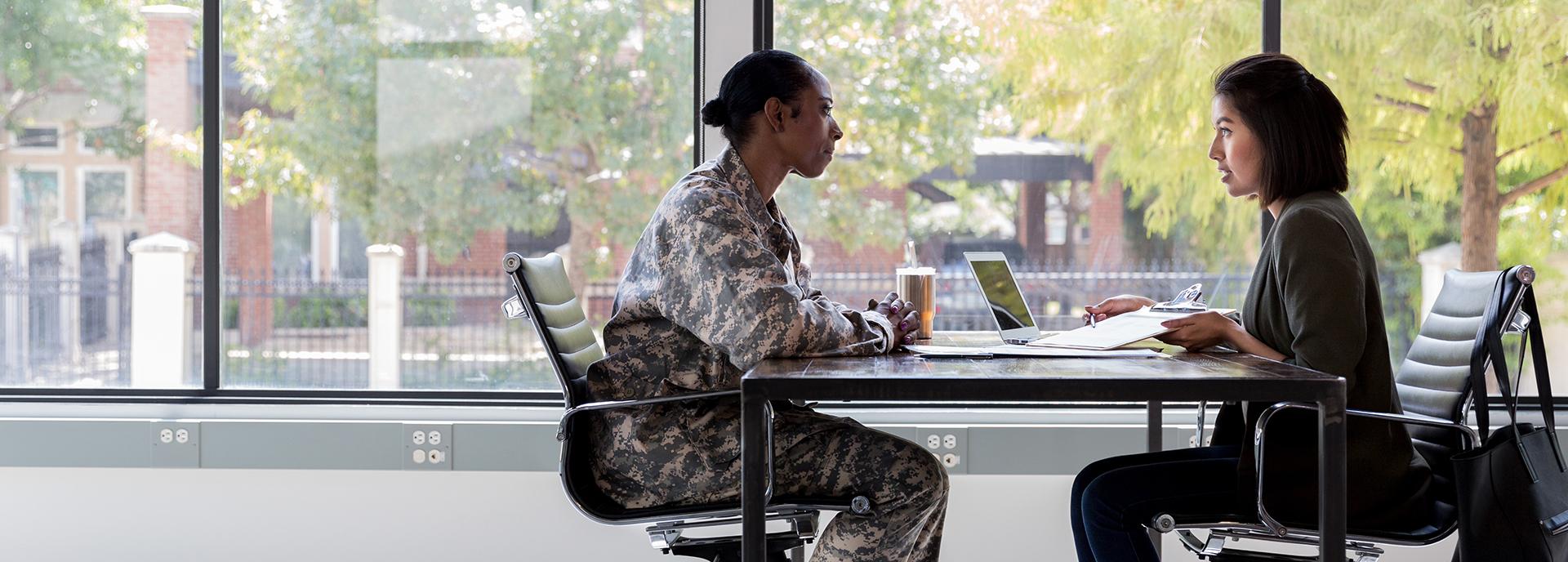 Military veteran sits with financial advisor