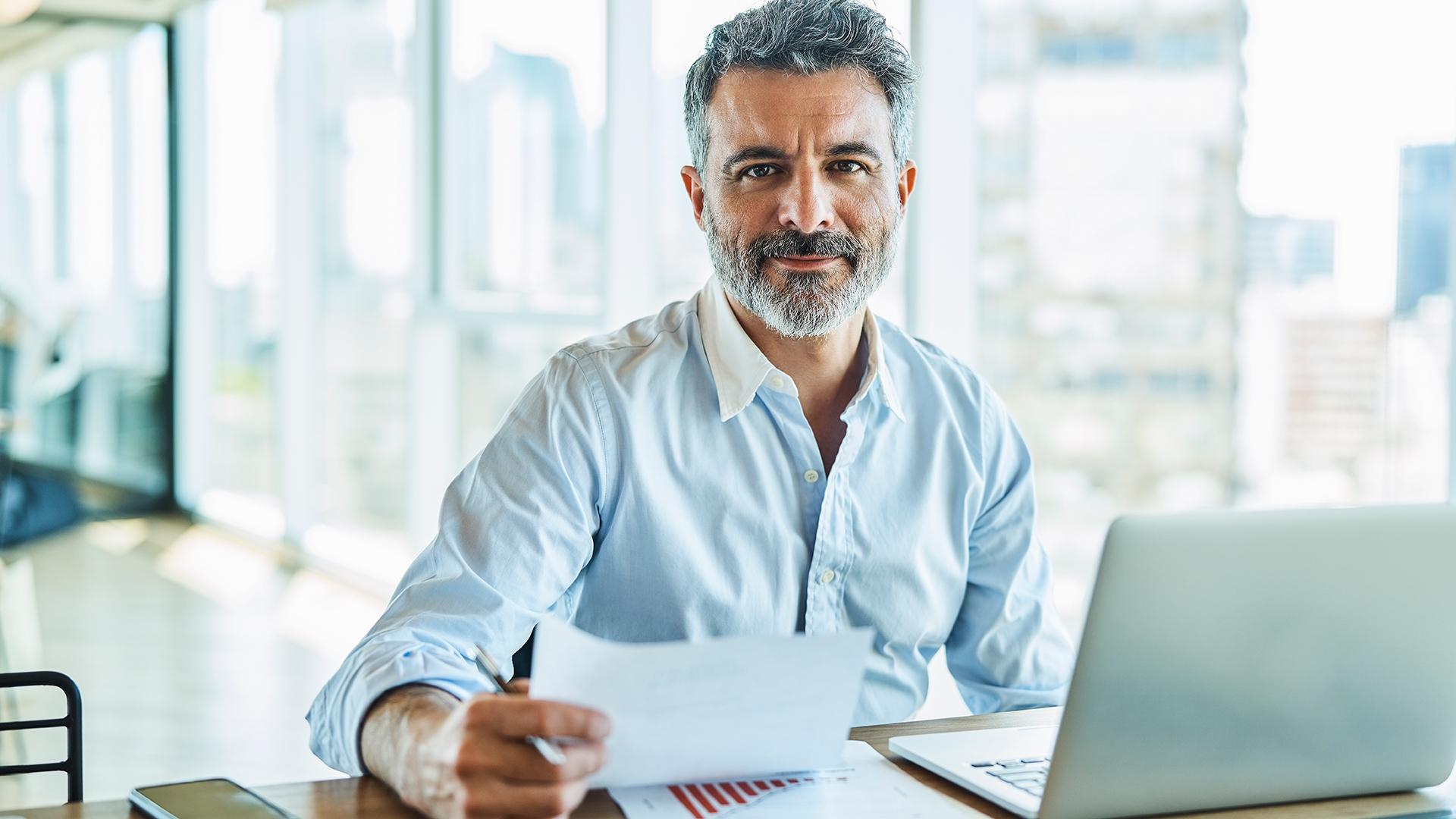 Middle aged man working at his desk