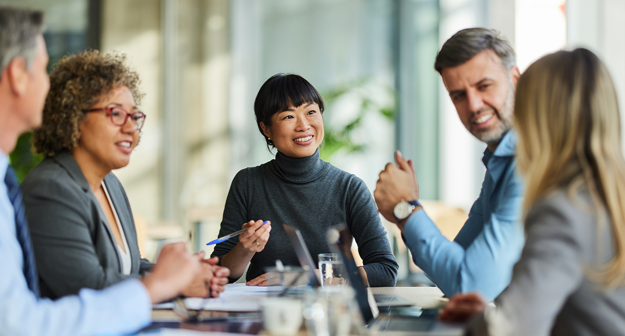 Group of professional coworkers meeting together and smiling