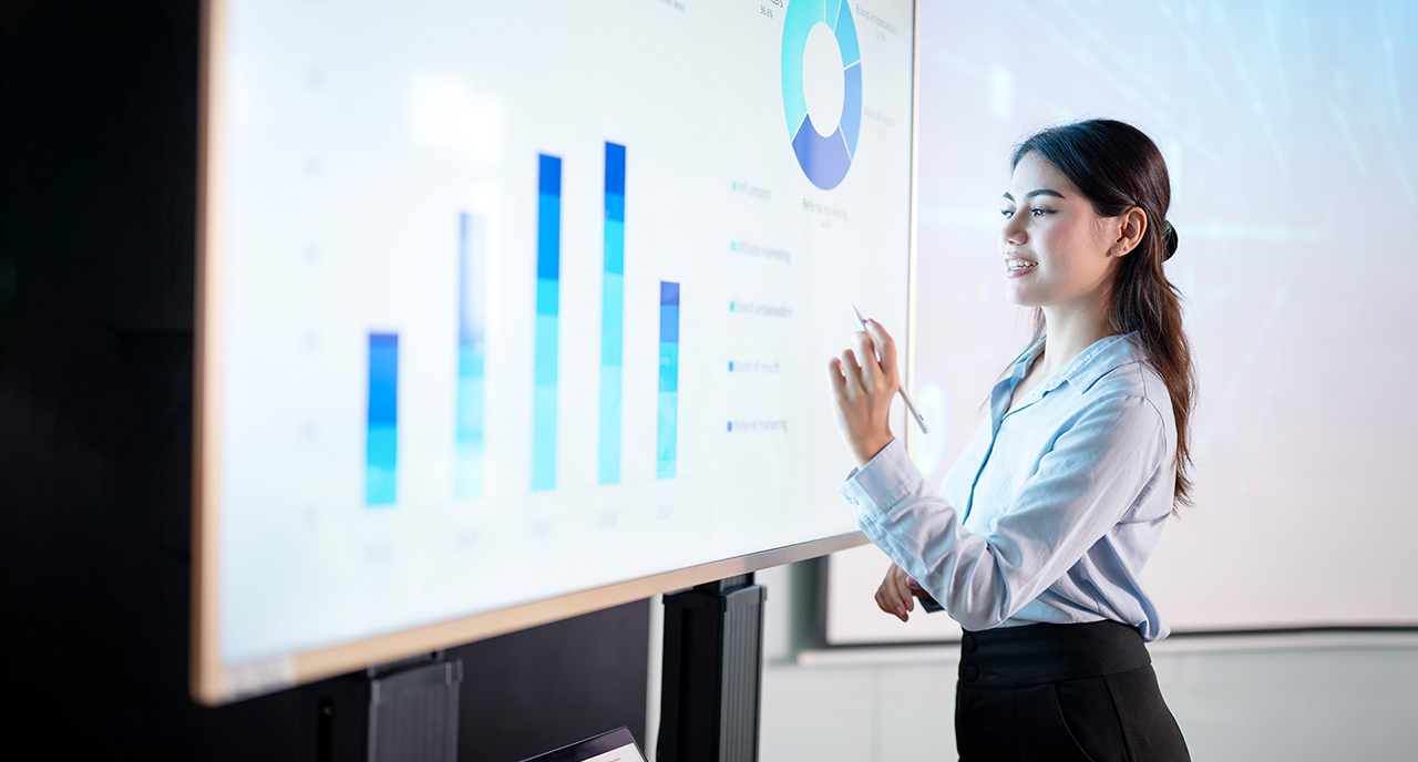 Woman working on a presentation on the white board