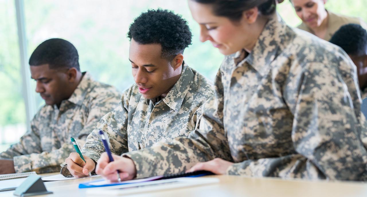 Group of military servicemen writing letters