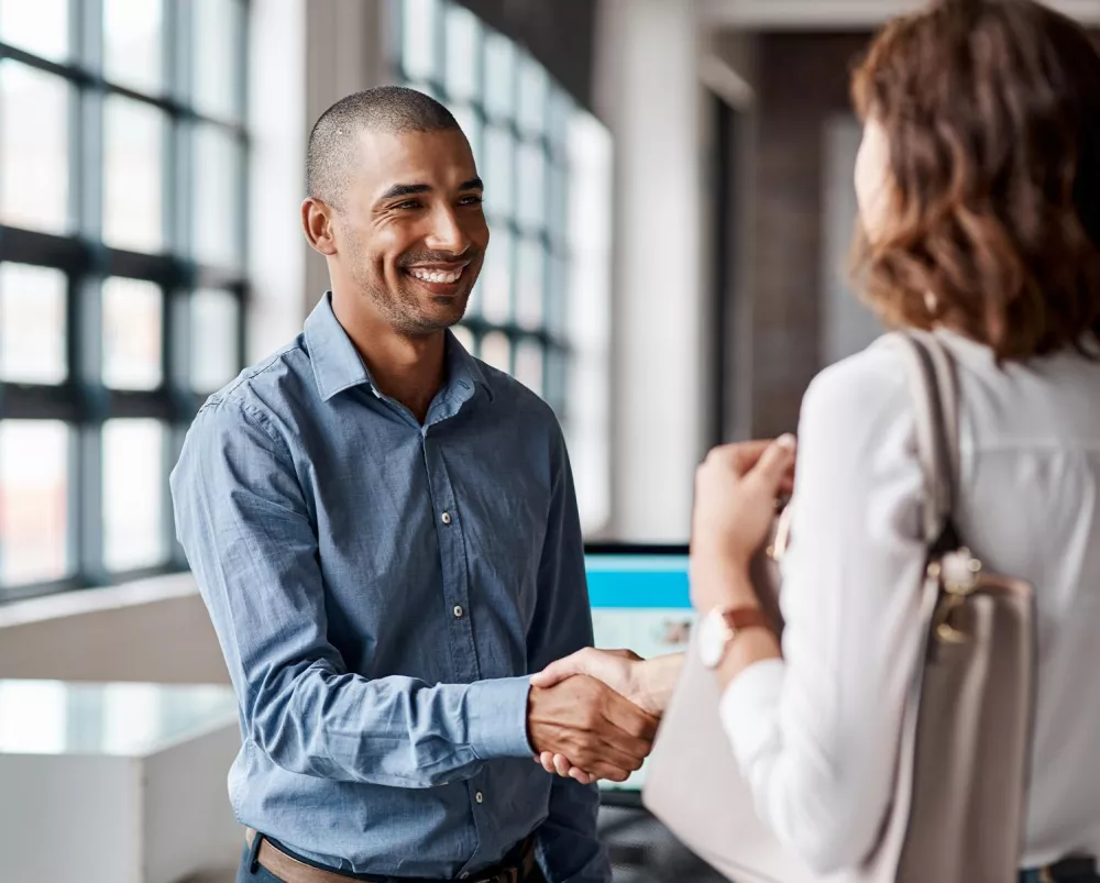 Male and female professional shaking hands