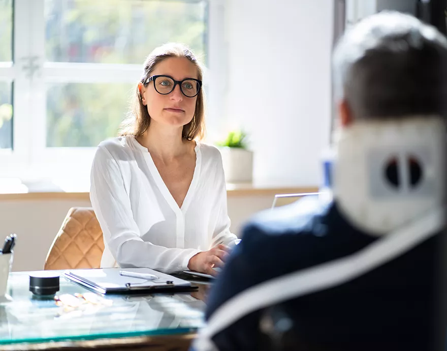 Woman talking to a man across the desk