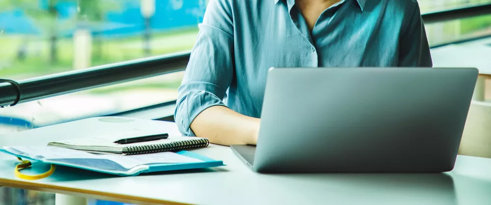 Close up of someone working at a computer