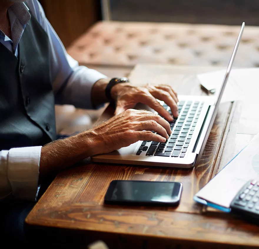 Close up of hands working on a tablet 