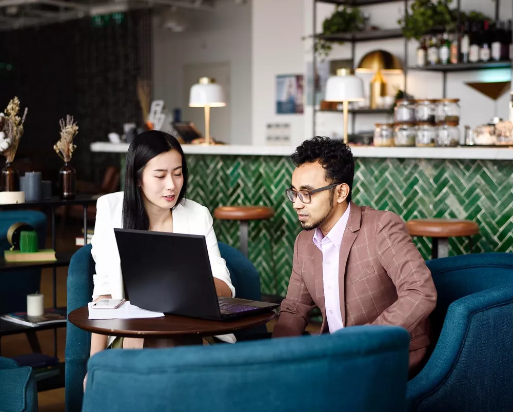 Two people talking and sitting at a table