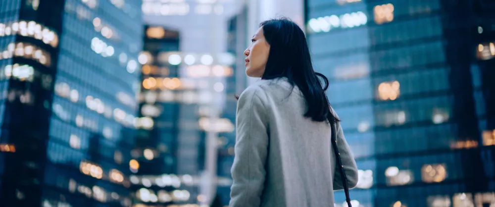 Asian American financial professional standing in a big city