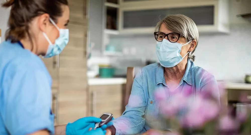 Healthcare professional helping a patient