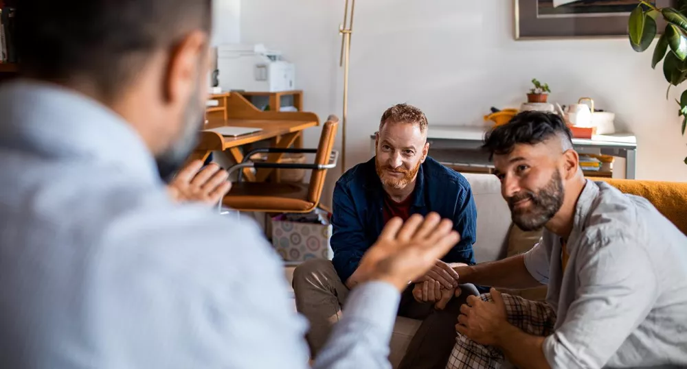 LGBTQ couple speaking with advisor