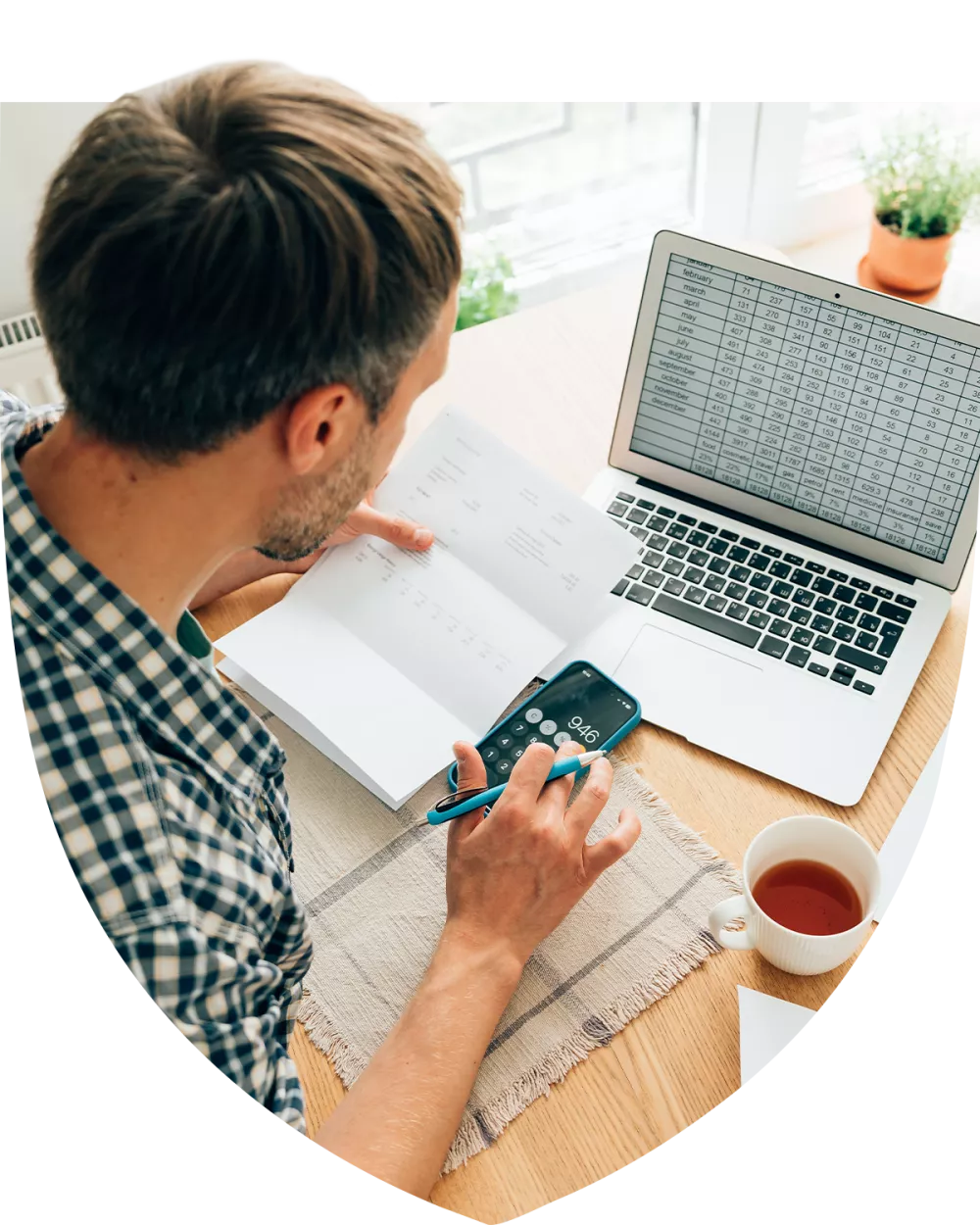 Man calculating numbers in a spreadsheet on his computer