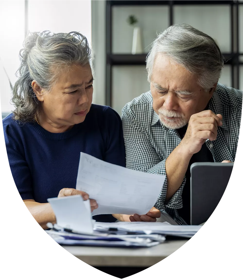 An elderly couple sitting down planning for retirement together