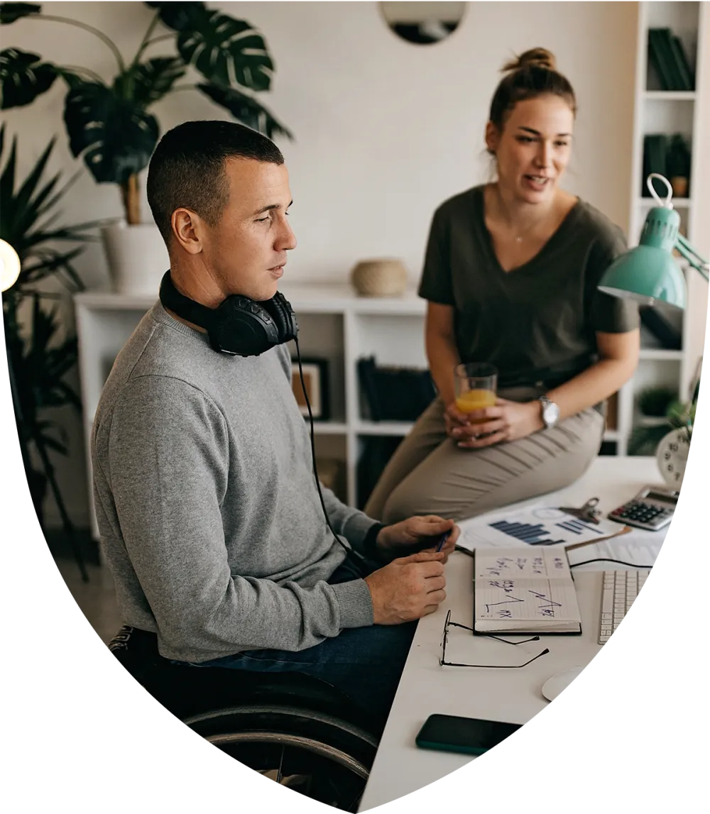 Man sitting in his wheelchair at his desk