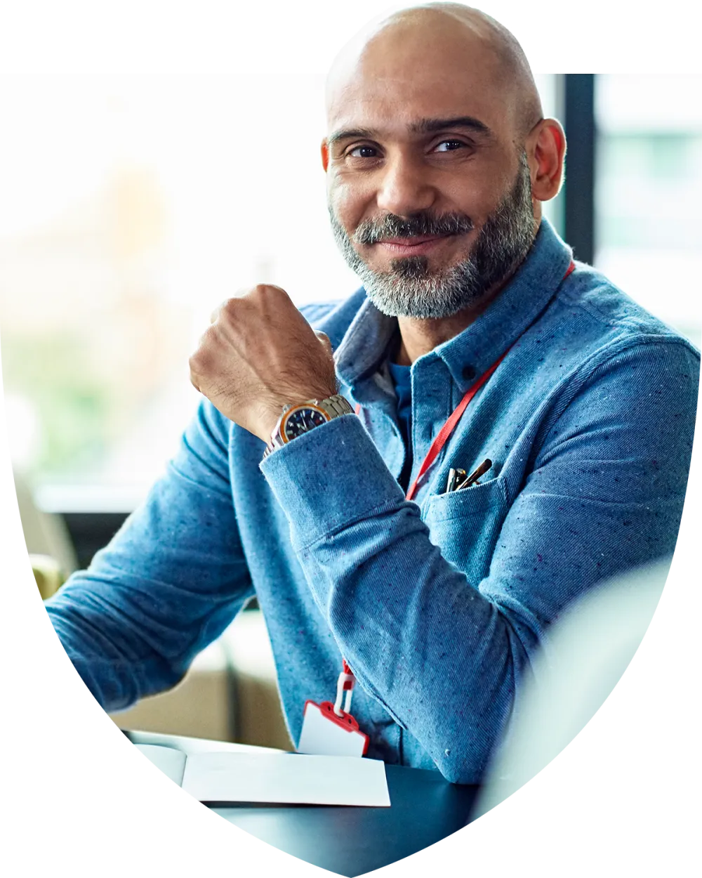 Middle aged man smiling while at his desk