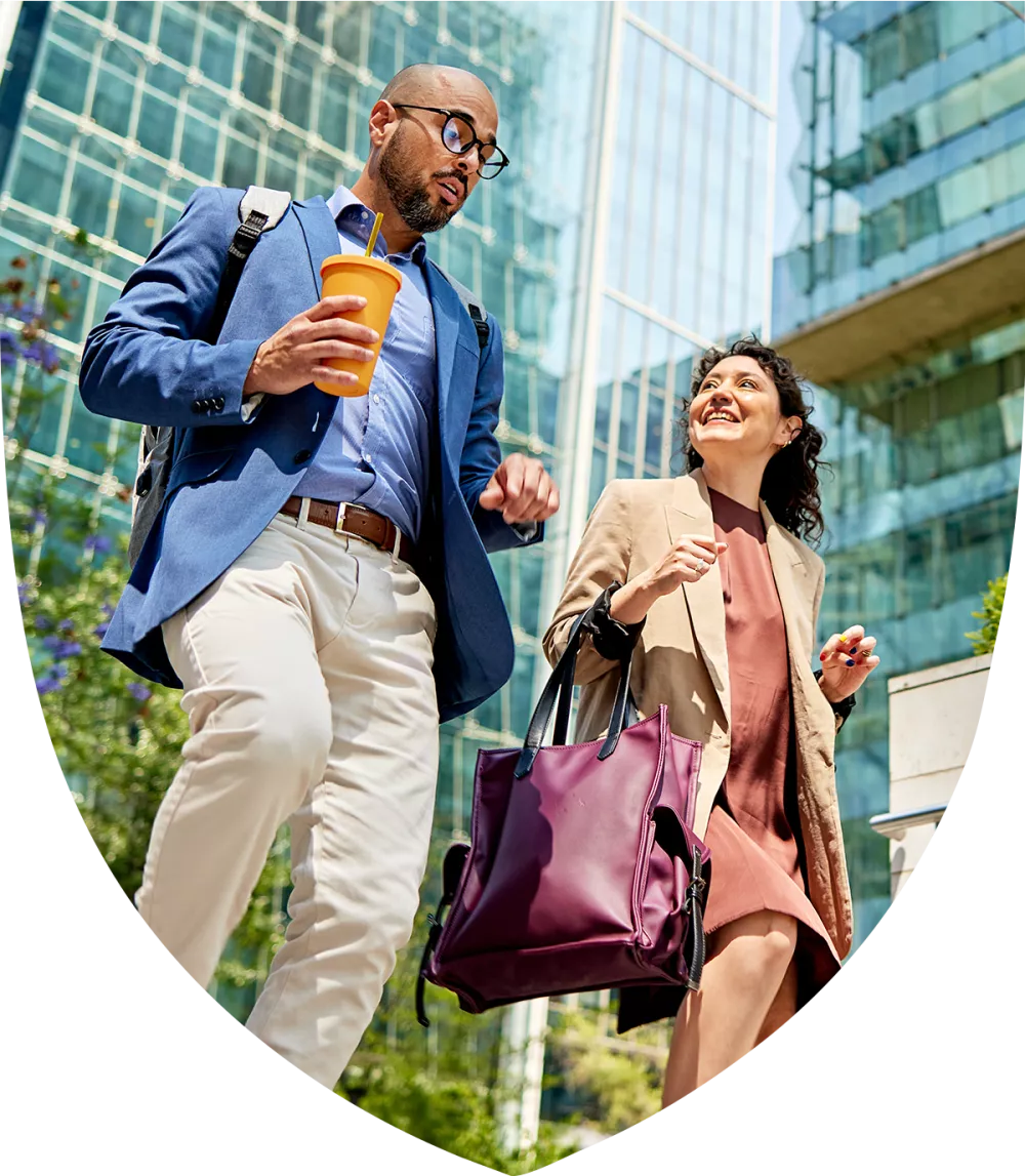 Two work colleagues walking and talking together 