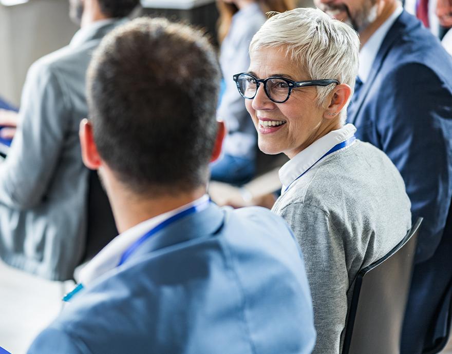 Older female advisor collaborating with a colleague 