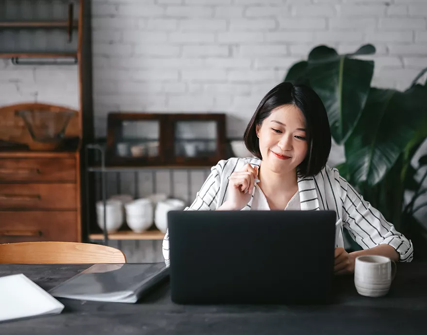 Woman working at her desk with a cup of coffee