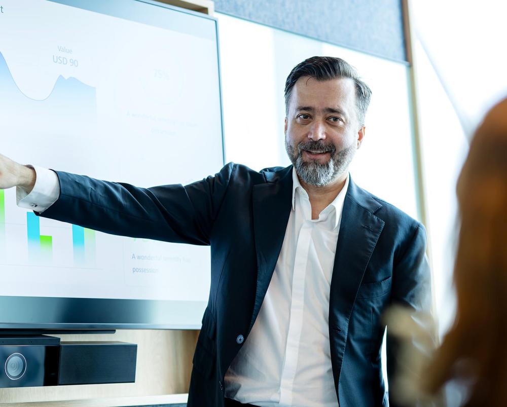 Man dressed in work suit giving a presentation