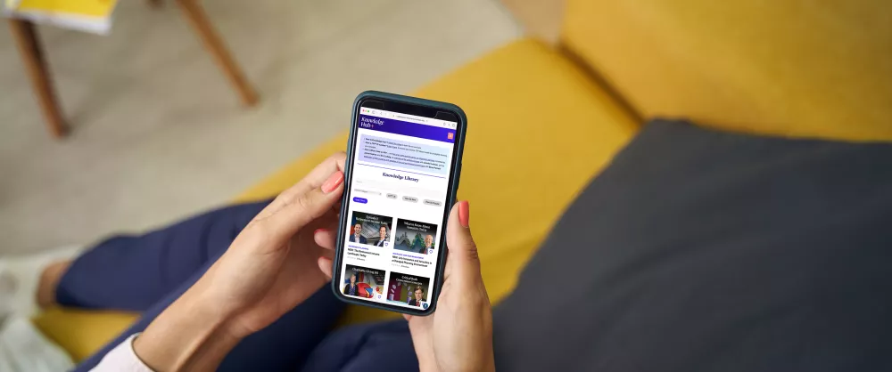 Woman browsing Knowledge Hub+ content on her phone