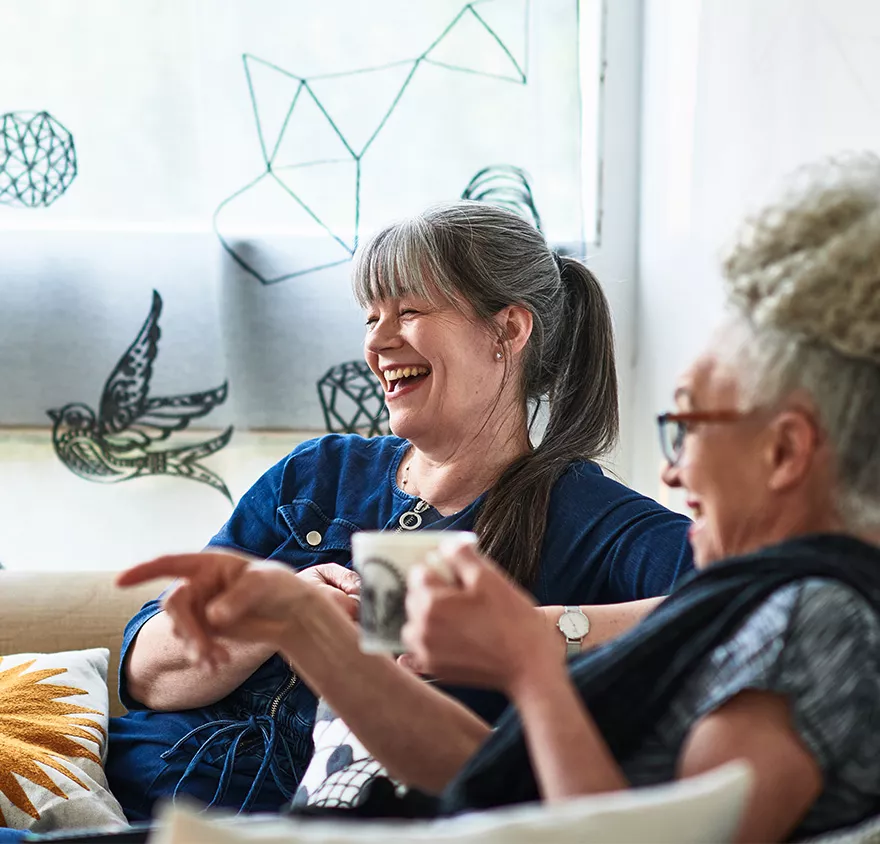 Retired female friends laughing together