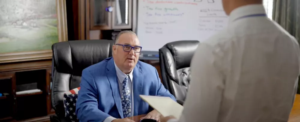 Cary Stamp sitting at his desk