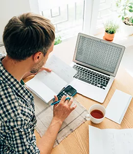 Man working on laptop doing his taxes