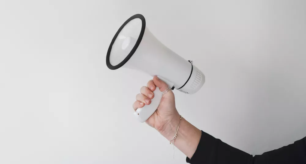 Hand holding megaphone