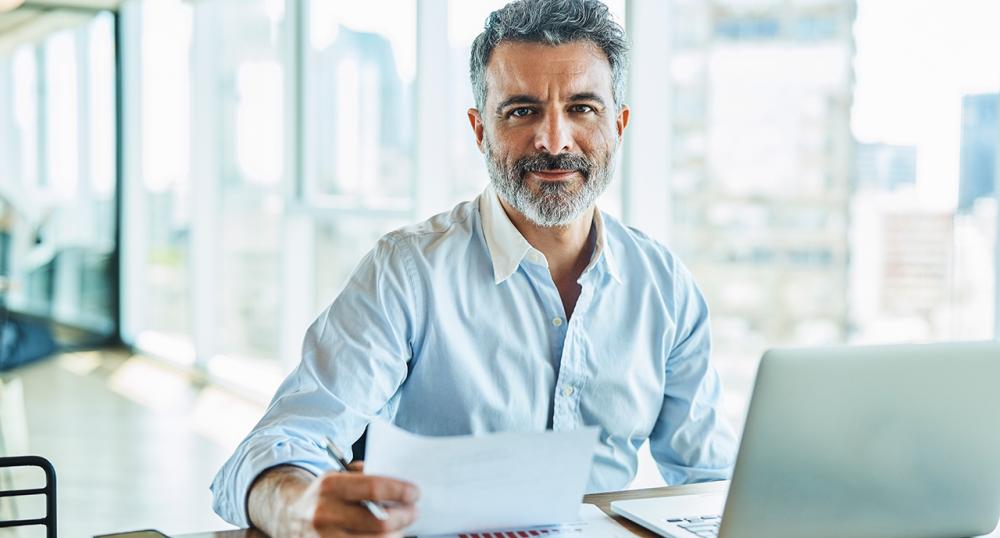 Middle aged man working at his desk