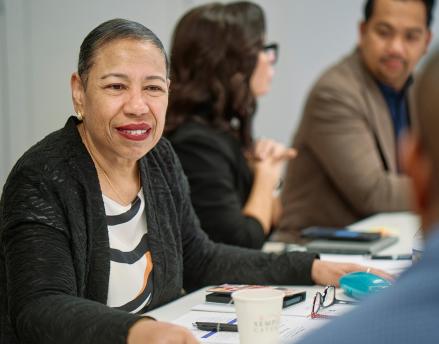 Angie Ribuffo sitting at a table with conference attendees