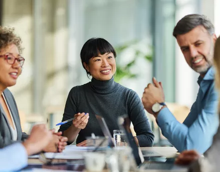 Group of professional coworkers meeting together and smiling