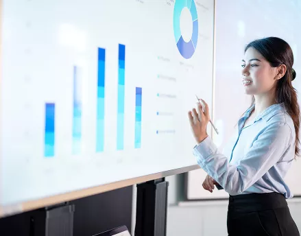 Woman working on a presentation on the white board