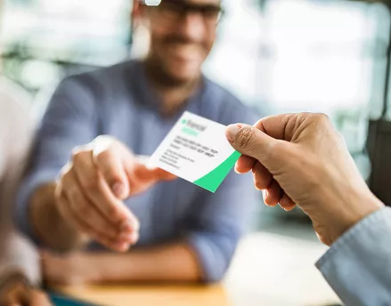 Advisor handing out their business card to a client