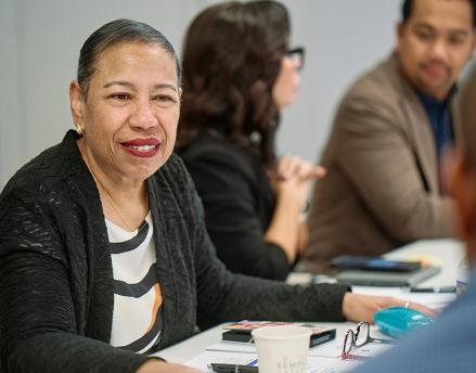 Angie Ribuffo sitting at a table with conference attendees