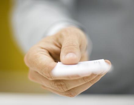 Hand stretched out handing in a card