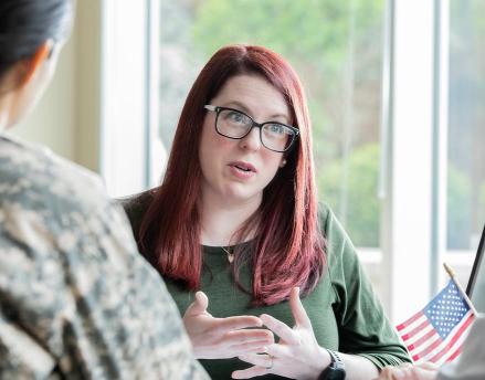 Female advisor meeting with a military service couple